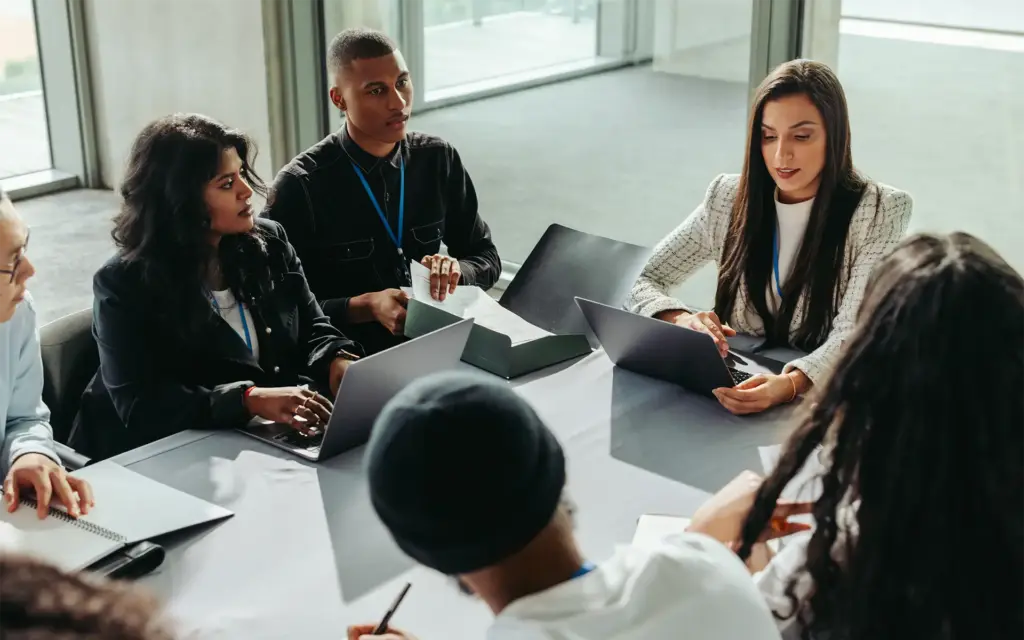 A team discussing benchmarking mistakes in a meeting
